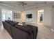 Spacious living room with a comfortable gray sofa, large TV, and stylish tile flooring throughout at 5161 Kingwell Cir, Oviedo, FL 32765