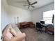 Cozy living room featuring a couch, piano, desk with computer, and ceiling fan at 5161 Kingwell Cir, Oviedo, FL 32765
