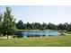 Scenic view of a tranquil pond with lush green surroundings and wildlife at 5161 Kingwell Cir, Oviedo, FL 32765