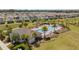 Aerial view of community pool and clubhouse surrounded by lush landscaping at 5291 Meredrew Ln, St Cloud, FL 34771