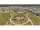Aerial view of community park with playground, pool, and landscaped walking trails at 5291 Meredrew Ln, St Cloud, FL 34771