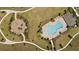 Aerial view of a community park featuring a pool, playground, walking paths, and green space at 5291 Meredrew Ln, St Cloud, FL 34771