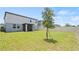 Well-maintained backyard with green lawn, privacy fence, and a screened patio at 5291 Meredrew Ln, St Cloud, FL 34771