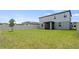 Large, well-manicured backyard with lush grass, a young tree, and a privacy fence at 5291 Meredrew Ln, St Cloud, FL 34771