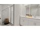Bright bathroom featuring double sinks, white cabinets and a glass-enclosed shower at 5291 Meredrew Ln, St Cloud, FL 34771