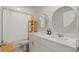 Clean, bright bathroom with double sinks, round mirrors, and a shower curtain at 5291 Meredrew Ln, St Cloud, FL 34771