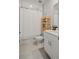 Bright bathroom featuring a shower with curtain, light wood shelving, and a modern vanity at 5291 Meredrew Ln, St Cloud, FL 34771