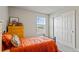 Well-lit bedroom with a cozy bed, window, closet, and stylish furnishings for a comfortable living space at 5291 Meredrew Ln, St Cloud, FL 34771