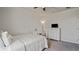 Cozy bedroom with soft carpet, white metal bed, dresser, and desk, creating a comfortable and inviting space at 5291 Meredrew Ln, St Cloud, FL 34771