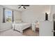 Bright bedroom featuring neutral carpet, white metal bed frame, desk and ample natural light from the window at 5291 Meredrew Ln, St Cloud, FL 34771