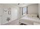 Comfortable bedroom featuring a white metal bed frame, closet, and a window for natural light at 5291 Meredrew Ln, St Cloud, FL 34771