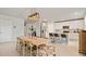 Bright, open-concept dining room with modern lighting next to a kitchen with white cabinetry at 5291 Meredrew Ln, St Cloud, FL 34771