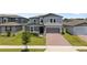 Charming two-story home features a well-manicured lawn, brick driveway, and inviting entry at 5291 Meredrew Ln, St Cloud, FL 34771