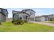 Well-maintained two-story home with a two-car garage, red brick driveway and manicured lawn at 5291 Meredrew Ln, St Cloud, FL 34771