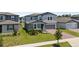Charming two-story home features a well-manicured lawn, brick driveway, and inviting entry at 5291 Meredrew Ln, St Cloud, FL 34771