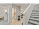 Hallway with wood floors, stairs, and an open view of the home's interior showcasing a light, airy feel at 5291 Meredrew Ln, St Cloud, FL 34771