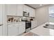 Charming kitchen features stainless steel appliances, and white cabinets with subway tile backsplash at 5291 Meredrew Ln, St Cloud, FL 34771