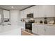Kitchen boasts quartz countertops, stainless steel appliances, and white cabinets with subway tile backsplash at 5291 Meredrew Ln, St Cloud, FL 34771