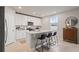 Chic kitchen with white cabinetry, center island with bar stools, and modern appliances at 5291 Meredrew Ln, St Cloud, FL 34771