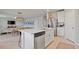 Open-concept kitchen flows into the living and dining areas, featuring a large island with stainless appliances at 5291 Meredrew Ln, St Cloud, FL 34771