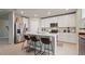 Modern kitchen with stainless steel appliances, white cabinets, and a center island with seating at 5291 Meredrew Ln, St Cloud, FL 34771