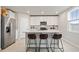 Bright kitchen with stainless steel appliances, quartz countertops, and breakfast bar seating at 5291 Meredrew Ln, St Cloud, FL 34771