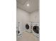 This laundry room features a tile floor, a washer, and a dryer at 5291 Meredrew Ln, St Cloud, FL 34771