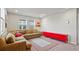 Cozy living room with a sectional sofa, rug, and bright red media console at 5291 Meredrew Ln, St Cloud, FL 34771