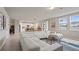 Bright living room with oversized sectional couch, large windows, and modern finishes at 5291 Meredrew Ln, St Cloud, FL 34771