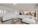 Open-concept living area with bright neutral walls, modern furnishings, and open kitchen at 5291 Meredrew Ln, St Cloud, FL 34771