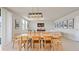 Large living room and dining room with modern lighting and tile flooring at 5291 Meredrew Ln, St Cloud, FL 34771