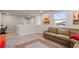 Open loft area with a comfortable sofa, natural light, and neutral carpeting at 5291 Meredrew Ln, St Cloud, FL 34771