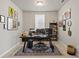 Home office with a black desk, area rug, and decorative wall art at 5291 Meredrew Ln, St Cloud, FL 34771