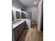 Bathroom featuring a double sink vanity, tile flooring, and a glass-enclosed shower at 567 Viceroy Ct, Kissimmee, FL 34758