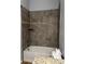 Bathtub-shower featuring a tiled shower and tub, with neutral colored walls, with tile accent at 567 Viceroy Ct, Kissimmee, FL 34758