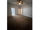 Spacious carpeted bedroom with neutral walls and multiple doors leading to other rooms at 567 Viceroy Ct, Kissimmee, FL 34758