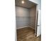 Walk-in closet with wood-look flooring and wire shelving for optimal storage and organization at 567 Viceroy Ct, Kissimmee, FL 34758