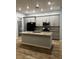 Modern kitchen featuring gray cabinets, granite countertops, stainless steel appliances, and a center island at 567 Viceroy Ct, Kissimmee, FL 34758