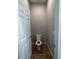 Small toilet room with a white toilet, neutral walls, and wood-look tile flooring at 567 Viceroy Ct, Kissimmee, FL 34758