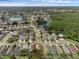 This aerial view highlights the home's location in a neighborhood near a lake and forest at 5729 Norman H Cutson Dr, Orlando, FL 32821