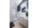 A modern bathroom with a walk-in shower with glass door, a floating vanity, and an LED mirror at 5729 Norman H Cutson Dr, Orlando, FL 32821
