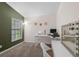 Cozy bedroom space featuring neutral walls, natural light and a workspace area with an accent mirror at 5729 Norman H Cutson Dr, Orlando, FL 32821