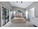 A bedroom with tile floors, a ceiling fan, and sliding glass door that leads out to the yard at 5729 Norman H Cutson Dr, Orlando, FL 32821