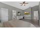 A bedroom with gray walls, a walk-in bathroom, and tile floors throughout at 5729 Norman H Cutson Dr, Orlando, FL 32821