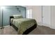 Comfortable bedroom with a bed, soft green bedding, and a window letting in natural light at 5729 Norman H Cutson Dr, Orlando, FL 32821
