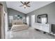 A bedroom with gray walls, tile flooring, and a bed with a white headboard and a ceiling fan at 5729 Norman H Cutson Dr, Orlando, FL 32821