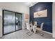 A dining area with a glass table, white chairs, with a view of the patio and a navy accent wall at 5729 Norman H Cutson Dr, Orlando, FL 32821