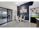 Dining area with seating, modern wall decor, and glass doors leading to outdoor patio space at 5729 Norman H Cutson Dr, Orlando, FL 32821