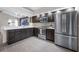 Modern kitchen equipped with stainless appliances, dark wood cabinets, and adjacent living area at 5729 Norman H Cutson Dr, Orlando, FL 32821
