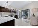 Modern kitchen with stainless steel appliances, sleek countertops, and sliding glass doors to patio at 5729 Norman H Cutson Dr, Orlando, FL 32821